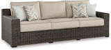 Signature Design by Ashley Coastline Bay Nuvella Weather Resistant Fabric Outdoor Sofa with Cushion and 4 Throw Pillows - Photo 1